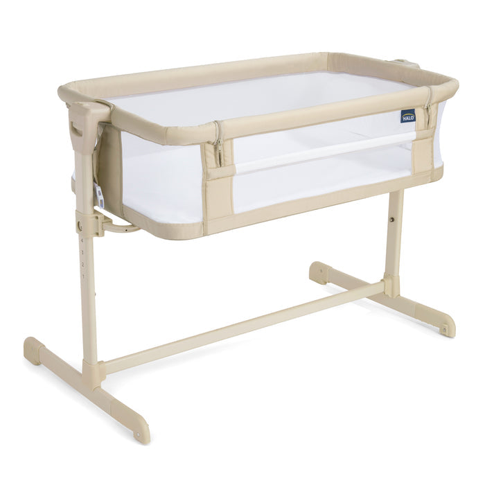 The HALO 2-in-1 Bedside BassiNest Sleeper is a beige and white bassinet with breathable mesh sides, adjustable height, a sturdy metal frame, and a drop-down side panel for easy access.