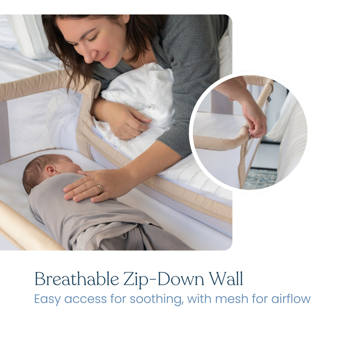 A woman leans over the HALO 2-in-1 Bedside BassiNest Sleeper with a zip-down breathable mesh wall, reaching to soothe her swaddled baby. An inset shows easy unzipping for access. Text: "Breathable Zip-Down Wall. Airflow & easy soothing.