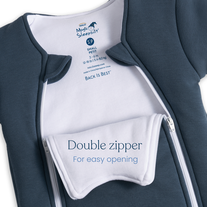 A blue Baby Merlin's Magic Sleepsuit® 100% Cotton by HALO, size small, features white lining and double zippers with an inner flap reading “Double zipper For easy opening”—ideal for infants transitioning out of swaddles.