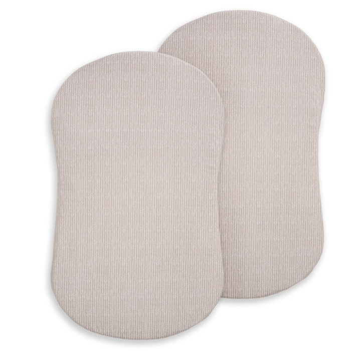 Two light beige, oval-shaped HALO BassiNest® Fitted Sheets (2-pack) crafted from 100% organic cotton with subtle vertical stripes, shown overlapping on a white background—ideal for newborns and gentle comfort.
