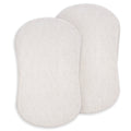 Two oval, textured white pads with rounded edges—HALO BassiNest® Fitted Sheet 100% Organic Cotton 2-Pack—are shown slightly overlapping on a white background, suggesting softness ideal for baby bedding.