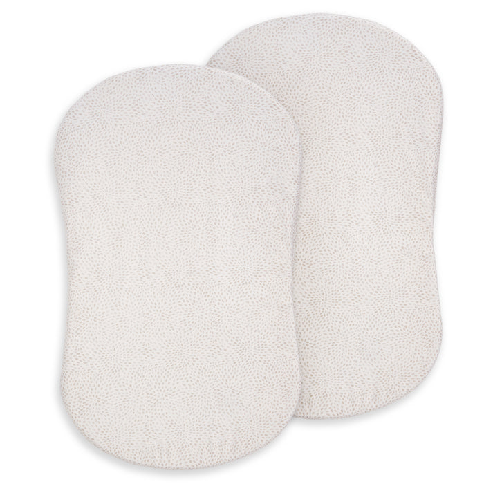 Two oval, textured white pads with rounded edges—HALO BassiNest® Fitted Sheet 100% Organic Cotton 2-Pack—are shown slightly overlapping on a white background, suggesting softness ideal for baby bedding.