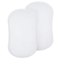 Two white, oval-shaped pads made of 100% organic cotton are shown side by side. These HALO BassiNest® Fitted Sheets come in a 2-pack and are ideal for use as newborn bassinet sheets.