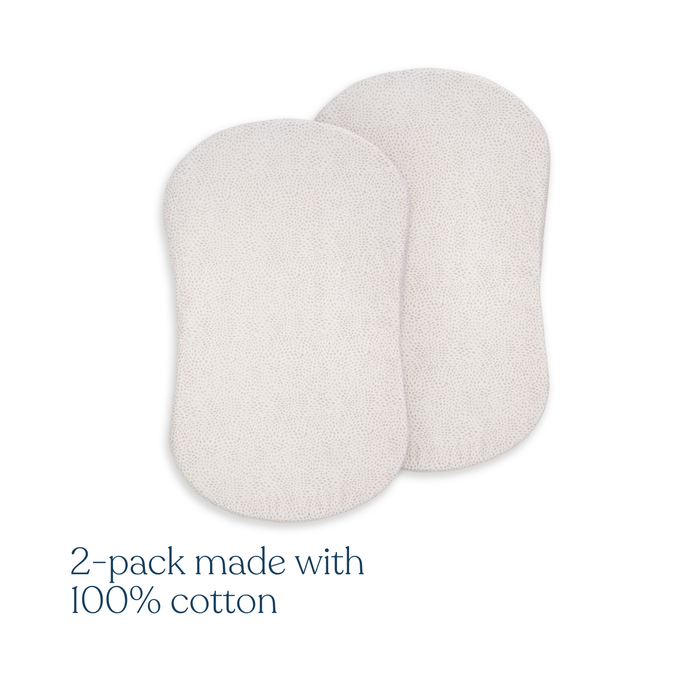 Two light-colored, oval BassiNest® Fitted Sheets from HALO, made with 100% organic cotton, are displayed side by side on a white background. Text below reads: HALO BassiNest® Fitted Sheet 100% Organic Cotton 2-Pack.