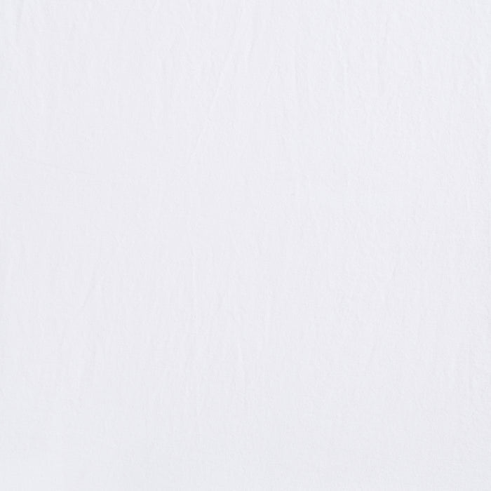 A close-up of a white textured surface with subtle creases, resembling the gentle pattern found on the HALO BassiNest® Fitted Sheet 100% Organic Cotton 2-Pack.