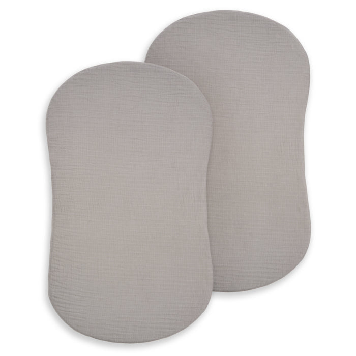 Two rectangular, storm grey, 100% organic cotton muslin pads overlap on a white background—perfect as HALO BassiNest® Fitted Sheet 2-Pack for breathable, comfortable baby bedding.