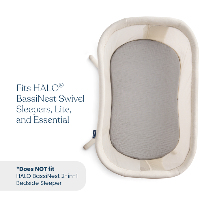 Top-down view of a light-colored bassinet and fitted mattress pad. The HALO BassiNest® Fitted Sheet 100% Organic Cotton Muslin 2-Pack fits all BassiNest Swivel Sleepers, Lite, and Essential models.