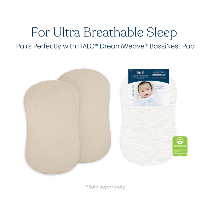 Two beige BassiNest® Fitted Sheets (100% organic cotton muslin, 2-pack) by HALO and a packaged patterned white HALO DreamWeave pad are shown. "For Ultra Breathable Sleep" is highlighted with a GREENGUARD certification icon visible.