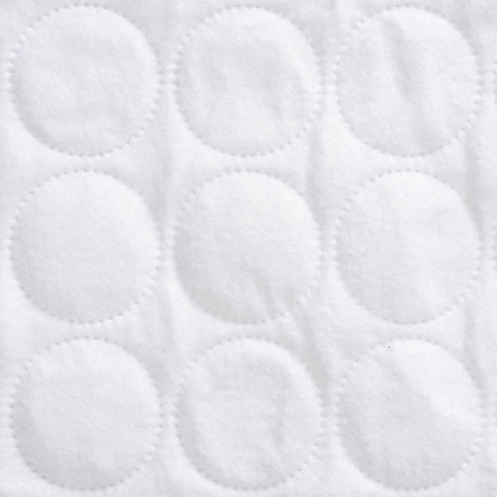Close-up of the HALO BassiNest® Protective Cover’s white, textured fabric, featuring evenly spaced stitched circles in a grid pattern, designed for a custom fit and soft protection for your BassiNest pad.