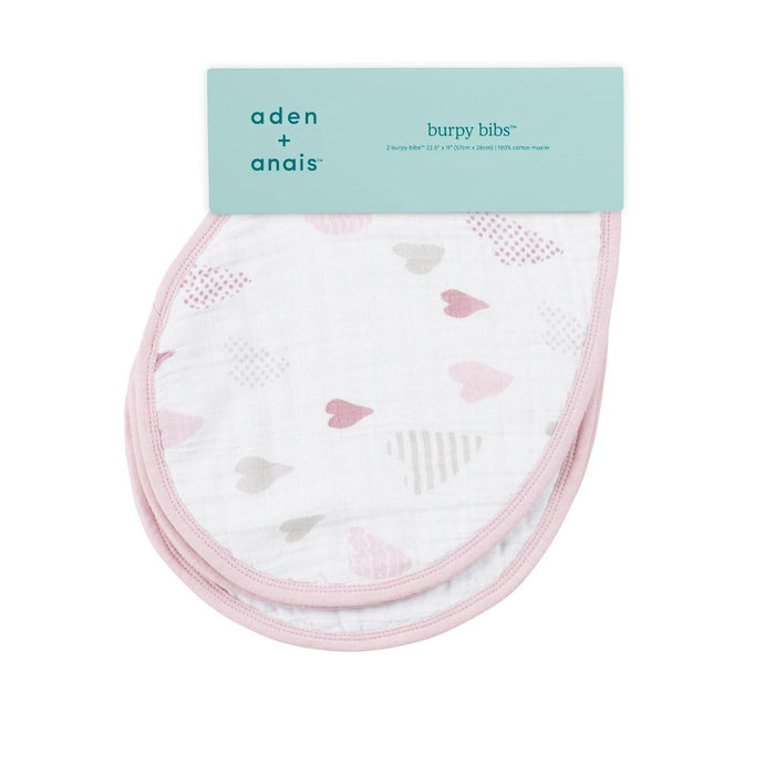 The aden + anais boutique burpy bibs 2 pack includes two absorbent muslin bibs with pink and gray hearts and a soft pink border.