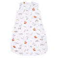 The aden + anais boutique 100% cotton muslin light sleep sack TOG 1.0 is sleeveless, white, and has a central zipper. It features playful illustrations of foxes, deer, and bears with subtle plants and flowers in muted colors for a luxurious finish.