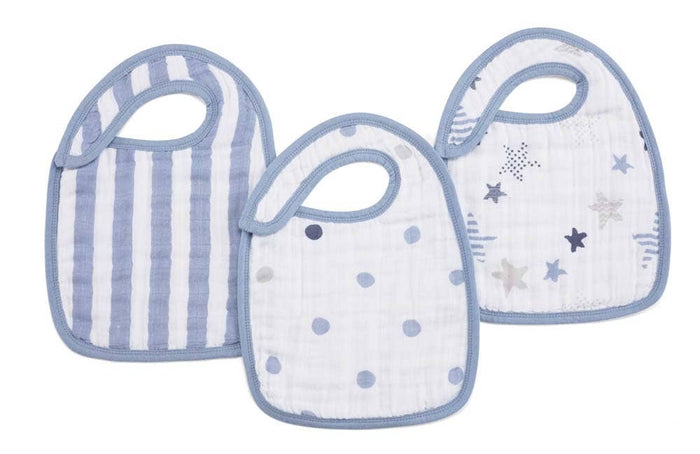 The aden + anais boutique 100% cotton muslin snap bibs 3-pack features adjustable blue-trimmed bibs with designs of blue and white stripes, polka dots, and stars in blue and gray shades. Made from absorbent muslin, they offer stylish practicality for little ones.