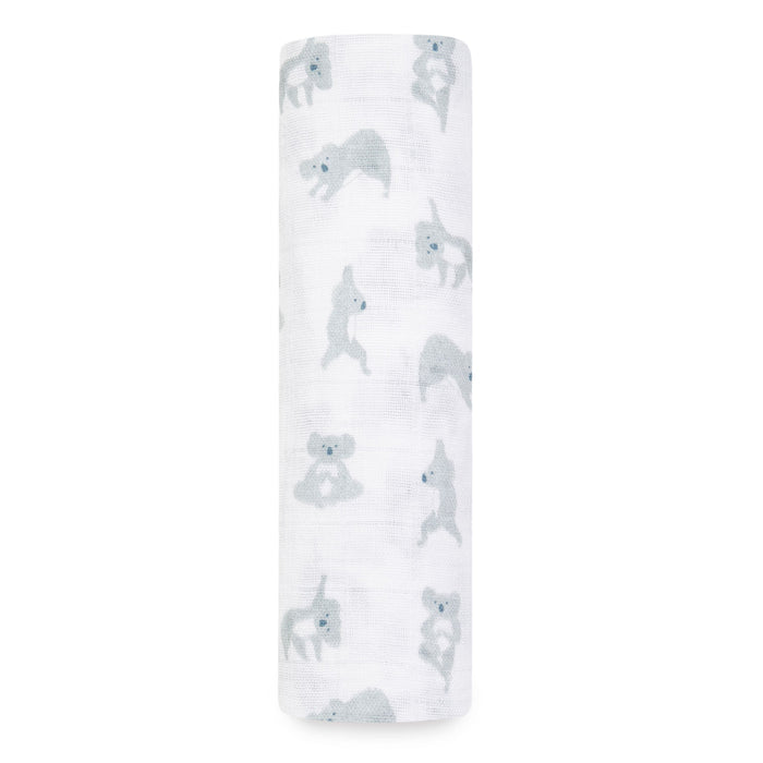 The aden + anais boutique 100% cotton muslin swaddle blanket is rolled up white and adorned with light blue koalas in various poses, perfect for adding charm to your diaper bag superhero setup.
