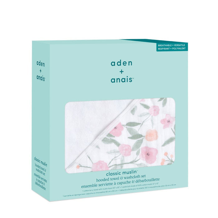 An aden + anais box holds a boutique 100% cotton oversized muslin backed towel and washcloth set, featuring a floral pattern in pink and green on light blue packaging.