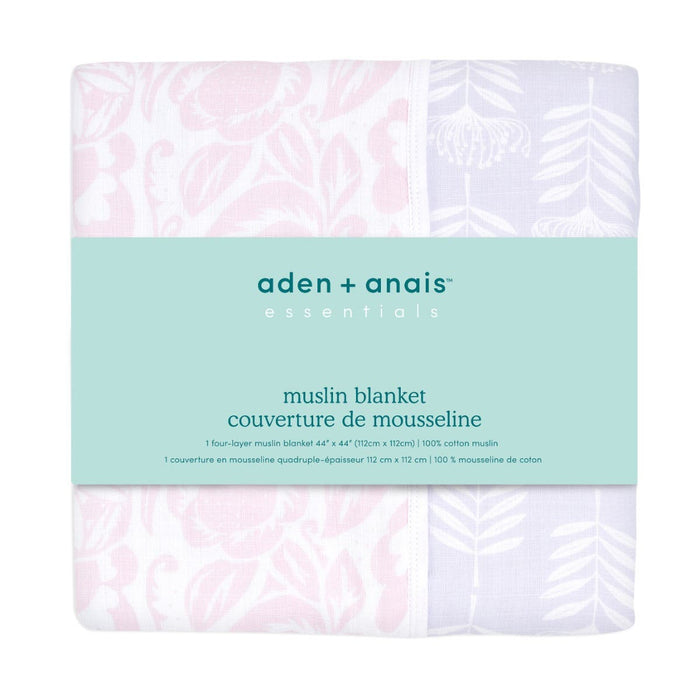 The aden + anais boutique cotton muslin dream blanket, with a soft pink and white floral design, is packaged showing a cozy cloud aesthetic. The light blue label on the package details the product in English and French.