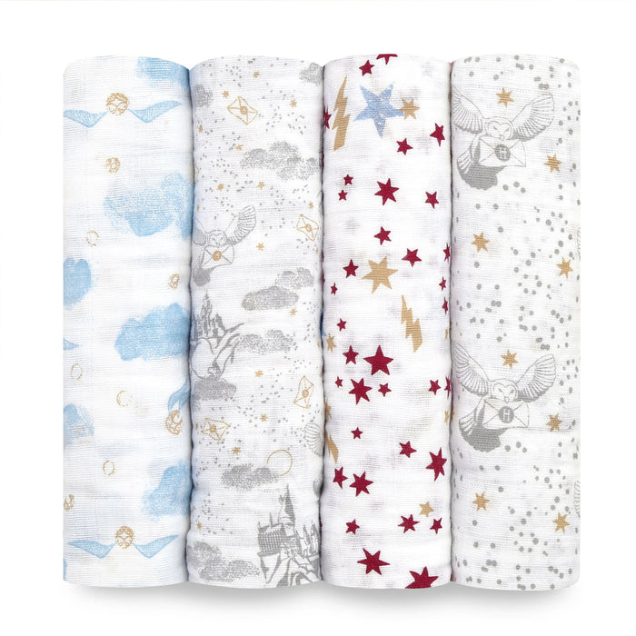 The boutique iconic 100% cotton muslin swaddle blanket 4 pack by aden + anais features enchanting Harry Potter-themed designs: blue snitches, magical castles, stars with lightning bolts, and owls surrounded by stars in a charming palette of blue, gray, red, and gold on white.