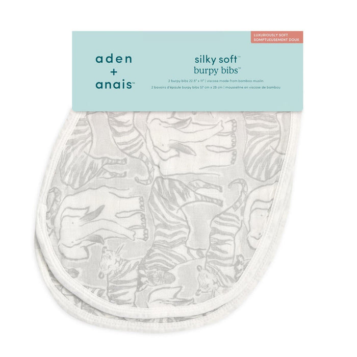 The aden + anais boutique silky soft burpy bib 2 pack showcases a gray animal print with elephants and zebras. Crafted from bamboo muslin, these bibs double as a burp cloth and emphasize their luxurious softness on the packaging.