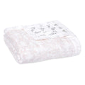 The aden + anais boutique silky soft muslin dream blanket offers cozy warmth with subtle floral patterns in light pink and darker motifs. Made from bamboo-infused viscose, this folded white quilt promises a silky touch for comfort seekers.