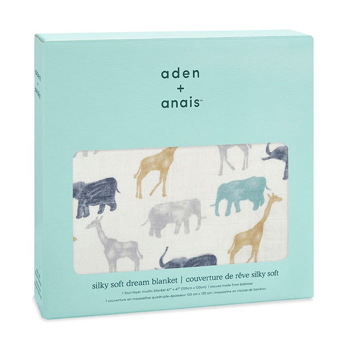 The aden + anais boutique silky soft muslin dream blanket, with ultra-smooth fabric, showcases elephants, giraffes, and rhinos in pastels on white. The light turquoise package includes product details.