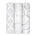 The boutique silky soft swaddle blanket 3 pack by aden + anais includes three bamboo-viscose blankets: one with a gray and white diamond design, another featuring elephants, and a third with a leaf pattern, all delivering ultimate comfort.