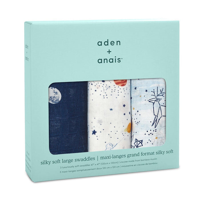 The aden + anais boutique silky soft swaddle blanket 3 pack includes bamboo-infused viscose swaddles featuring designs like navy with stars, white with stars and orange dots, and a white one with a deer illustration. It comes in light blue packaging with text descriptions.