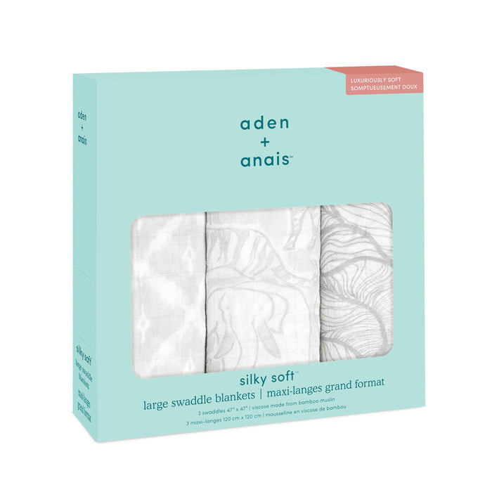 The aden + anais boutique silky soft swaddle blanket 3 pack comes in a teal box with a clear window showcasing three white, bamboo-infused viscose blankets featuring a subtle gray pattern. The package emphasizes their luxurious softness and breathability, crafted from premium bamboo material.