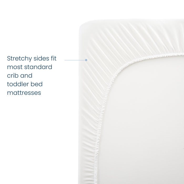 The image shows a close-up of HALOs Breathable Crib Mattress Cover with a soft, stretchy fabric edge. Text reads, Stretchy sides fit most standard crib and toddler bed mattresses. The photo highlights the corner and texture with waterproof lining for added protection.