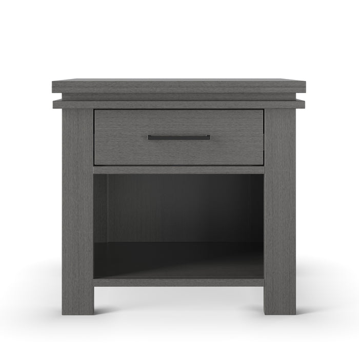 The Child Craft Denman Nightstand in Midnight Gray features a single drawer with a black handle and an open lower shelf, displayed against a white background.