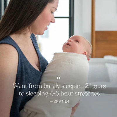 A woman in a blue tank top lovingly holds her swaddled baby. Text: “Went from barely sleeping 2 hours to sleeping 4-5 hour stretches — Brandi,” thanks to the HALO Eric Carle The Very Hungry Caterpillar Cotton Swaddle TOG 1.5.