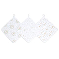 The aden + anais essential cotton muslin washcloths 3 pack includes three cloths with pastel floral wreaths, small dots, and animal patterns. Ideal for delicate skin, each cloth has a loop for hanging and is displayed in a row on a flat surface.
