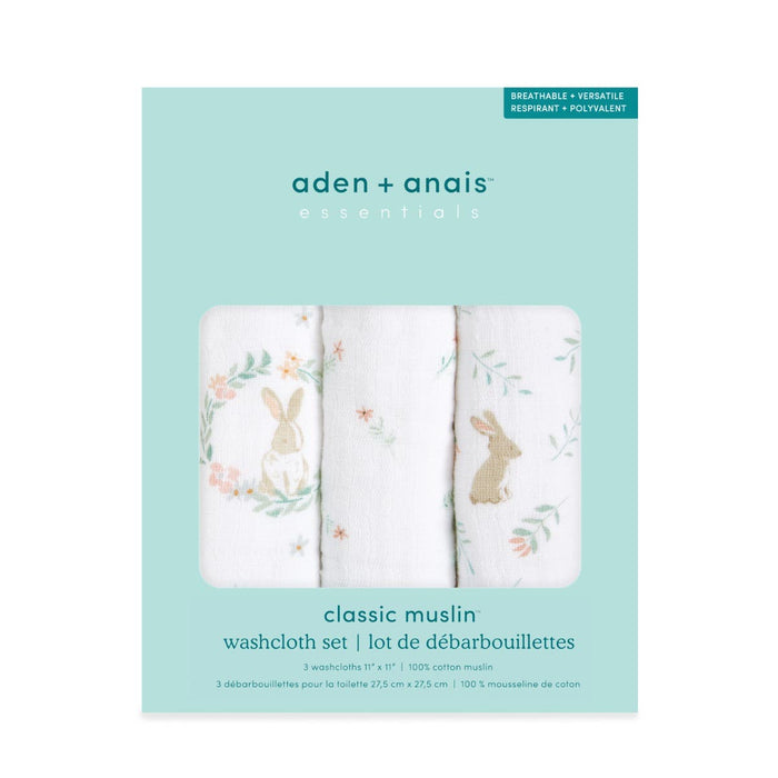The aden + anais essential cotton muslin washcloths 3 pack features aqua blue packaging with three washcloths displaying animal and floral designs, ideal for delicate skin. Breathable + versatile is written at the top, emphasizing the absorbent layers.