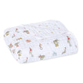 The aden + anais essentials cotton muslin dream blanket showcases a folded design with whimsical circus patterns of elephants, seals, and monkeys. This cozy cloud-themed blanket features a mix of muted colors and scattered small stars for added charm and comfort.