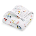 The aden + anais essentials cotton muslin dream blanket is a soft, quilted baby blanket with cozy, lightweight cotton muslin and colorful prints of cars, trees, and bunting flags.
