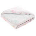 The aden + anais essentials cotton muslin dream blanket offers a soft, warm feel with a floral pattern in pink and blue on a light background. Crafted from cozy cotton muslin, it is absorbent and captures the essence of resting on a cozy cloud.