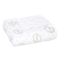 The aden + anais essentials cotton muslin dream blanket is folded and white, featuring a cute rabbit and floral wreath pattern in pastel colors for a cozy, cloud-like feel.