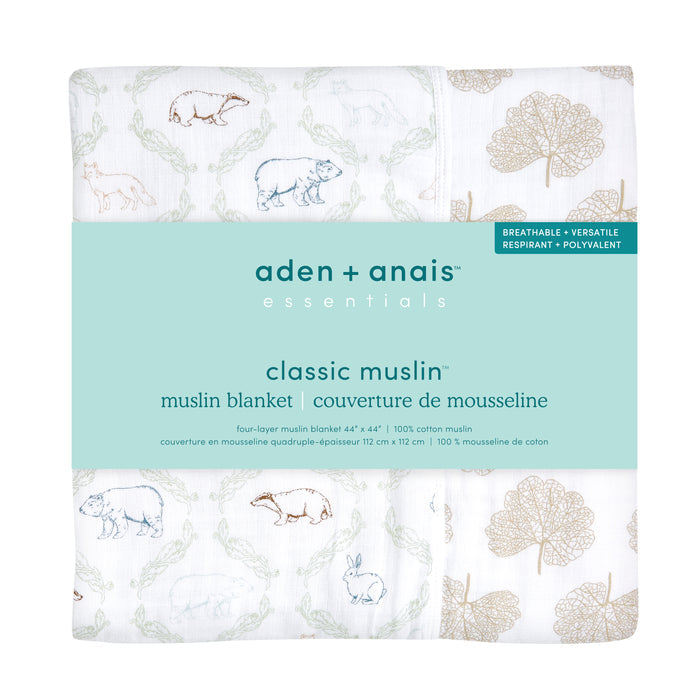 The aden + anais essentials cotton muslin dream blanket features animal illustrations like bears, cows, and camels with leaves in muted tones. Known for breathability and versatility, this absorbent cotton muslin blanket is ideal for any nursery.