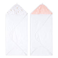 The aden + anais essentials cotton muslin hooded towels 2-pack includes a towel with white terry fabric and a multicolored animal print hood on the left, and another with a white base featuring a peach-colored hood with a subtle floral pattern on the right.
