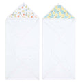 The aden + anais essentials cotton muslin hooded towels 2 pack features super absorbent white towels. The left towel has a fruit pattern with oranges and peaches inside the hood, while the right displays vibrant lemons on a blue background. Crafted from plush cotton terry for ultimate comfort.