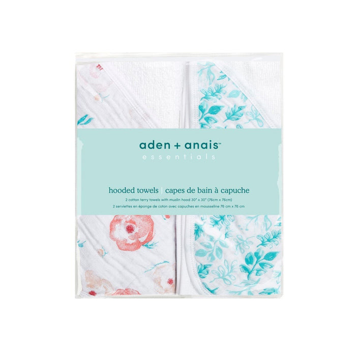The aden + anais essentials hooded towels 2 pack includes two cozy cotton muslin terry towels with floral designs in red and teal. Absorbent, the packaging details are in English and French, noting a size of 70 cm x 70 cm.