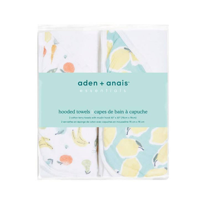 The aden + anais essentials cotton muslin hooded towels 2 pack is packaged in a clear wrap with a light blue label, featuring charming animal and fruit prints. Each super absorbent towel is plush and neatly folded.