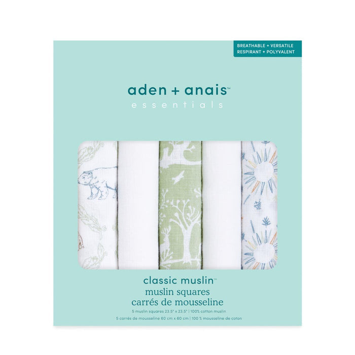 A package of aden + anais essentials cotton muslin musy squares 5 pack is shown, containing five 100% cotton squares with assorted green and blue floral and animal designs. The packaging highlights their breathability and versatility.