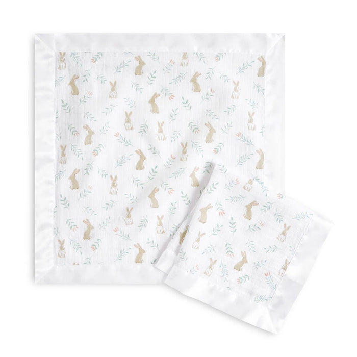The aden + anais essentials cotton muslin security blankets, a 2-pack, feature charming brown bunnies with green and pink foliage. One blanket is unfolded and the other folded. Made from 100% cotton muslin with white satin borders, theyre perfect for newborns and toddlers.