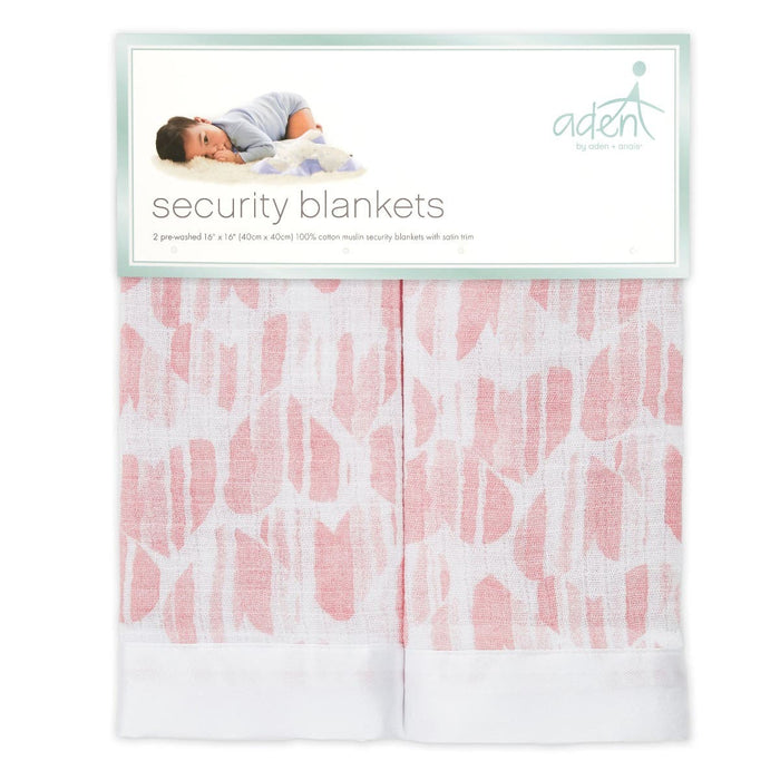 The packaging of aden + anais essentials cotton muslin security blankets 2 pack shows two folded blankets with pink and white patterns. The label features a baby lying down and text highlighting two pre-washed, soft 100% cotton muslin blankets, each sized 16 x 16.