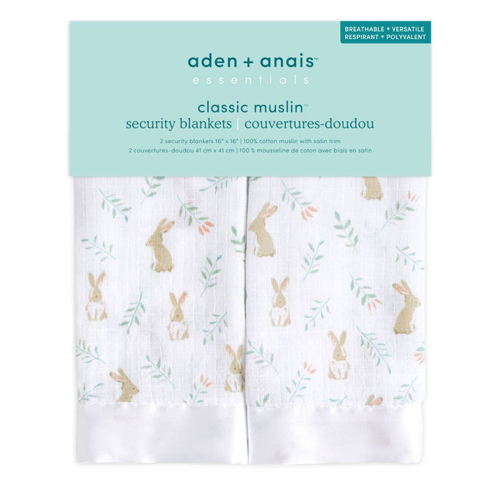 The aden + anais essentials cotton muslin security blankets 2-pack is designed for newborns and toddlers. This set offers soft, white blankets featuring a charming brown rabbit and green leaf pattern. Two 100% cotton muslin blankets, each measuring 16 x 16, are included.