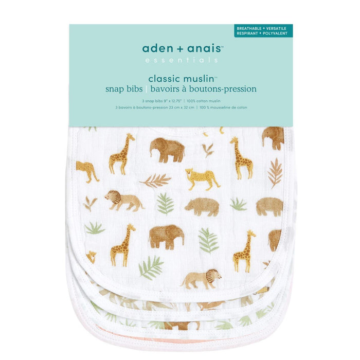 The aden + anais essentials cotton muslin snap bibs 3 pack includes three white bibs with charming animal and leaf patterns featuring giraffes, elephants, and lions. These bibs are made from three layers of absorbent cotton muslin.