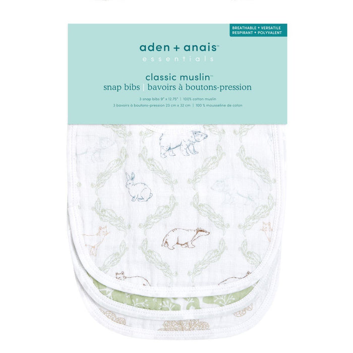 The aden + anais essentials cotton muslin snap bibs 3 pack is crafted from absorbent cotton muslin featuring soft pastel animal illustrations like rabbits, tortoises, and birds. The packaging emphasizes their breathable, versatile design that grows with your baby.