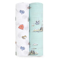 Two aden + anais essentials cotton muslin swaddle blankets are pictured. The left is white with colorful Harry Potter prints like mittens and a R sweater, while the right is light blue featuring sketches of a castle, clouds, and birds. Both are made from cozy cotton muslin.