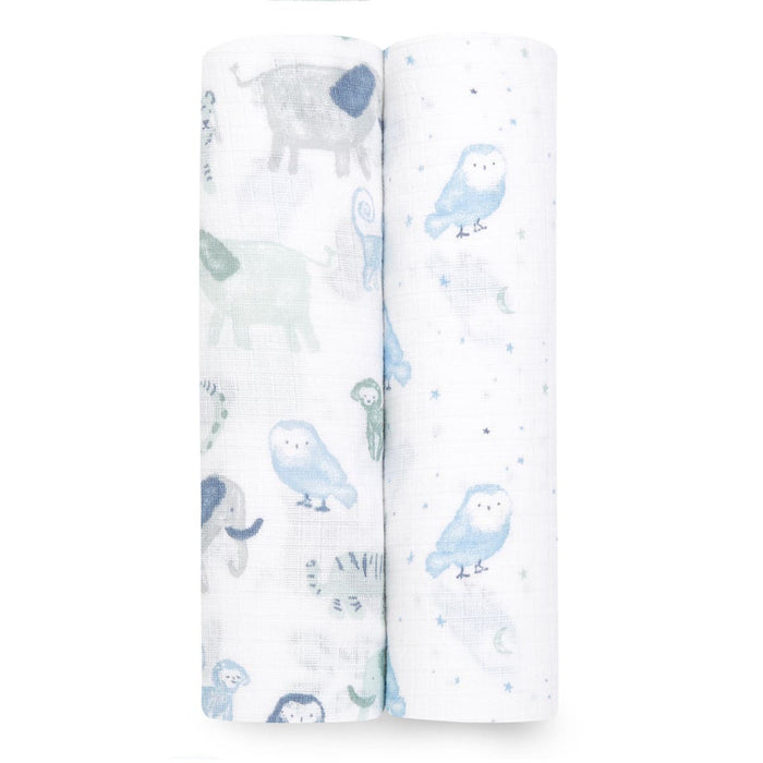 The aden + anais essentials cotton muslin swaddle blanket 2 pack includes two rolled blankets with charming animal and nature prints: one with elephants and owls, the other with owls, stars, and moons—all in soothing pastel hues for your little ones cozy comfort.