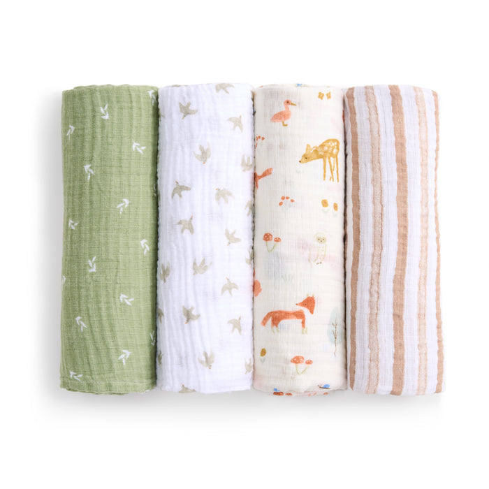 The aden + anais essentials cotton muslin swaddle blanket 4 pack features four vertically displayed swaddles: green with white birds, white with a light bird pattern, white with forest scenes, and white with brown stripes. These breathable and versatile blankets combine style and practicality.