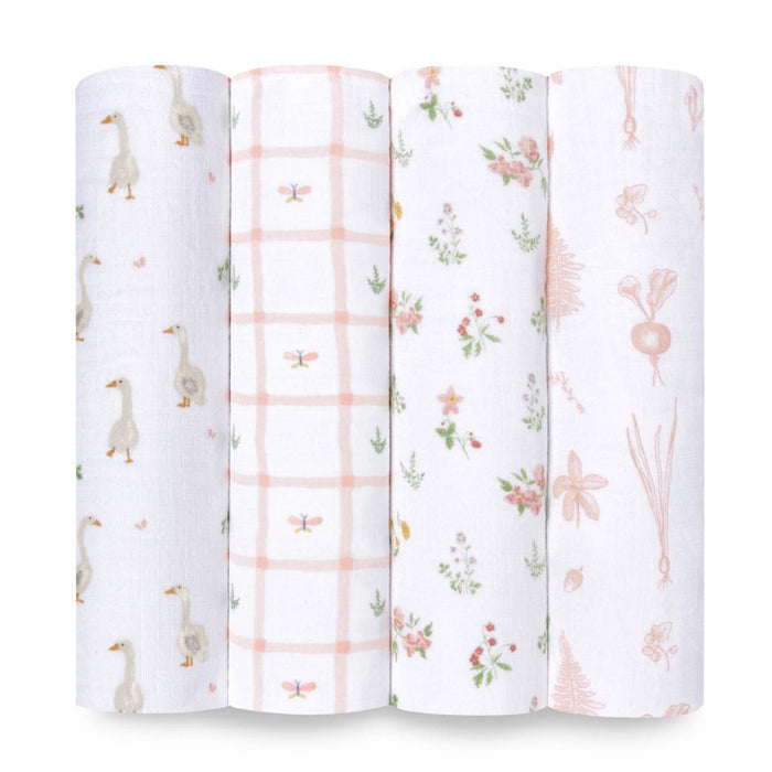 This set of four aden + anais essentials cotton muslin swaddle blankets includes designs of ducks, a pink grid with accents, floral patterns, and pink botanicals. These soft white and pastel-colored swaddles are nursery must-haves.